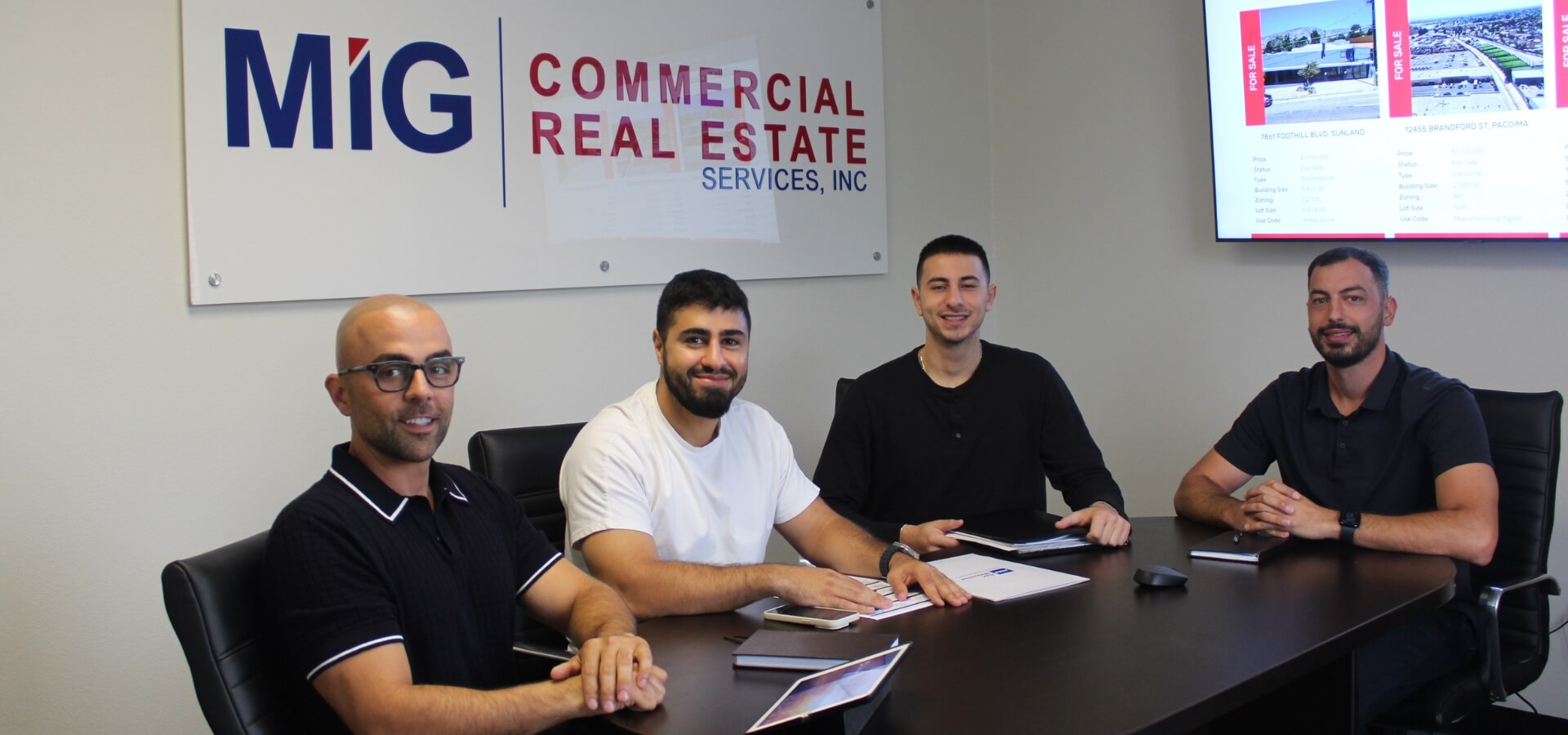 Aaron Voskani team photo in conference room